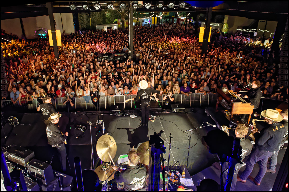 A packed New Orleans concert audience viewed from the stage