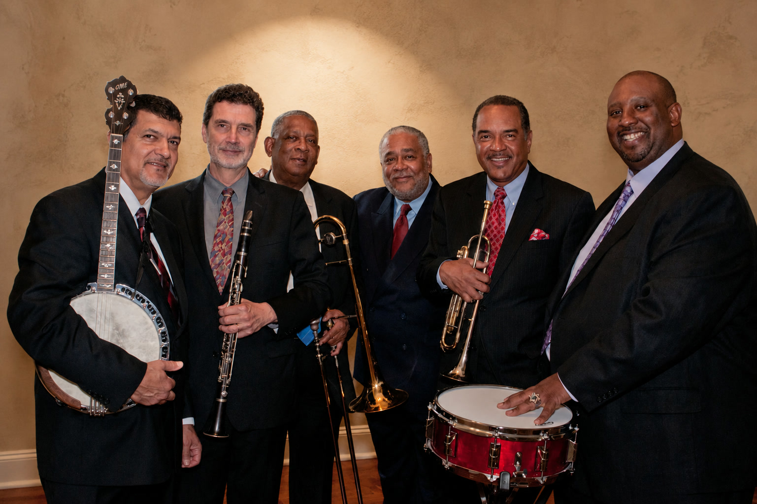 New Orleans jazz ensemble posed with banjo, clarinet, trombone, trumpet and drums