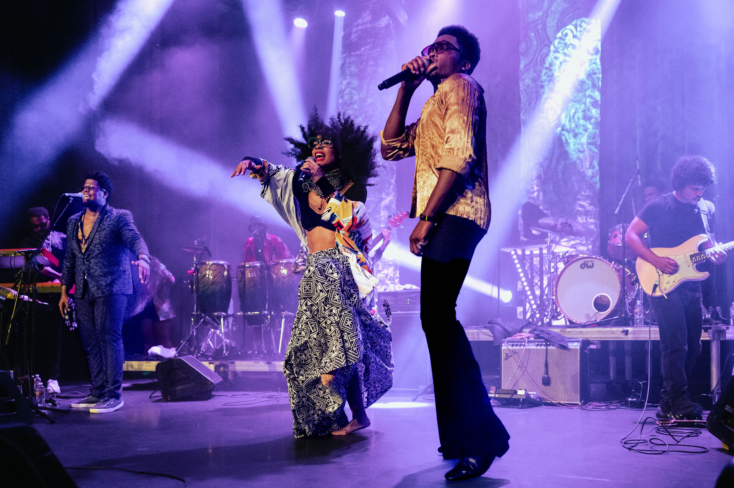 The Soul Rebels performing live beneath purple stage lights